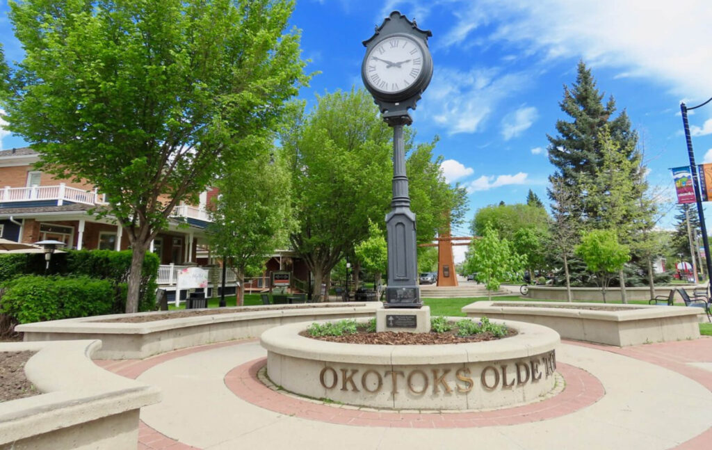 Okotoks Olde Town clock in vibrant park setting
