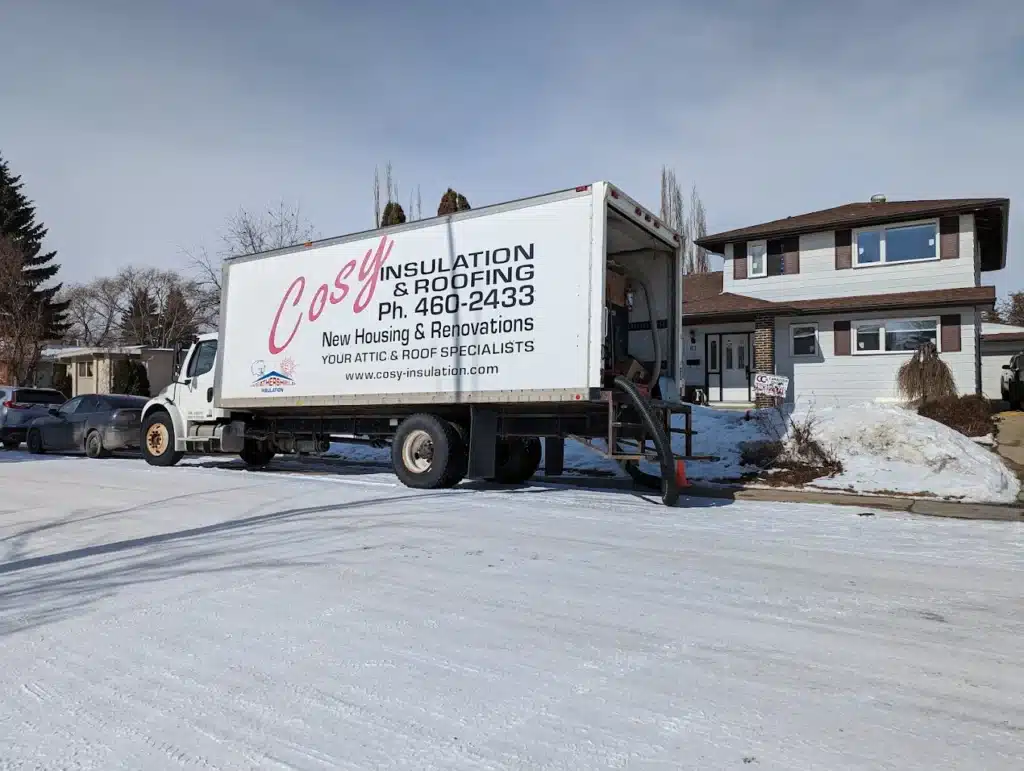 Insulation service truck parked outside suburban home in winter